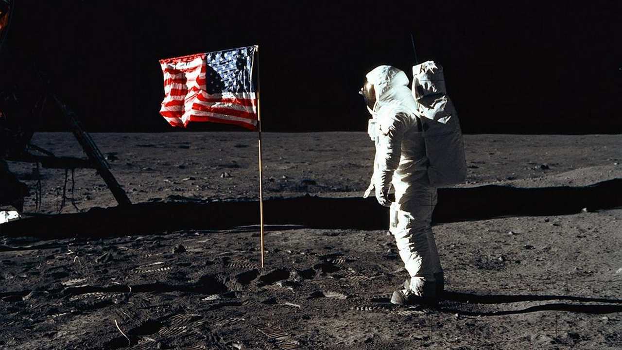 Astronaut Edwin E. Aldrin Jr., lunar module pilot of the first lunar landing mission, poses for a photograph beside the deployed US flag. Image: NASA
