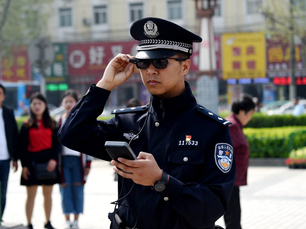 A police officer displays his AI-powered smart glasses in Luoyang, Henan province, China. Reuters