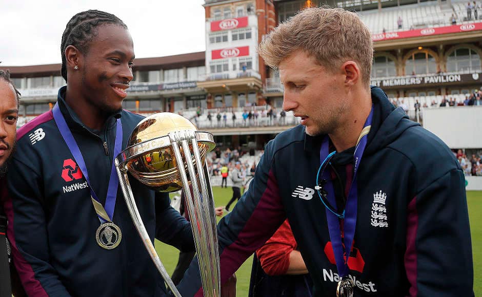 England’s Jofra Archer and Joe Root take a look at the World Cup trophy. While Archer impressed by taking 20 wickets in the tournament, Root aggregated 556 runs in their successful campaign. AP 