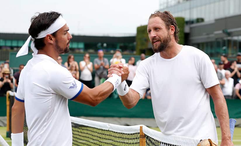 United States’ Tennys Sandgren, right, greets Italy’s Fabio Fognini at the net after winning their Men’s singles match during day six of the Wimbledon Tennis Championships in London, Saturday, July 6, 2019. (AP Photo/Alastair Grant)