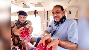 Ghaziabad DM, SSP take gov-provided chopper to shower flower petals on 'kanwarias' in district