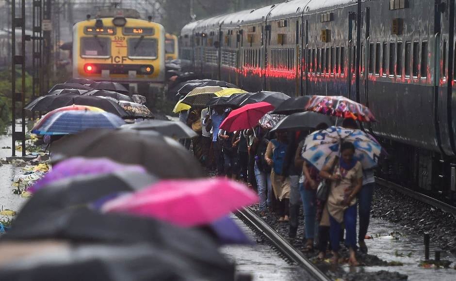 As local train services were hit, commuters walked on the railway tracks. PTI. As local train services were hit, commuters walked on the railway tracks. PTI.