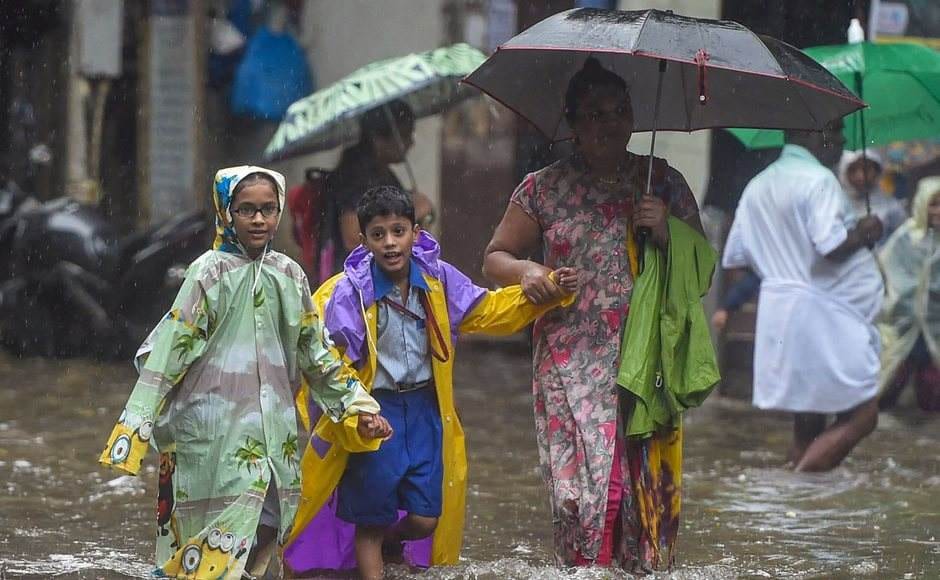 After a break of few days, heavy rains returned to Mumbai and its neighbouring areas on Monday morning, affecting road and rail traffic and briefly disrupting operations at the city airport. School children wade through a waterlogged street, following heavy monsoon rain in Mumbai. PTI After a break of few days, heavy rains returned to Mumbai and its neighbouring areas on Monday morning, affecting road and rail traffic and briefly disrupting operations at the city airport. School children wade through a waterlogged street, following heavy monsoon rain in Mumbai. PTI