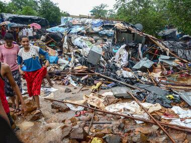 Debris seen after a portion of a compound wall collapsed on shanties adjacent to it in Malad, Mumbai. PTI