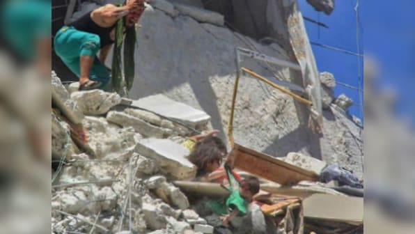Syrian girl, who clinged on to her baby sister's t-shirt in heart-breaking air-bombing photo, dies after saving younger one's life