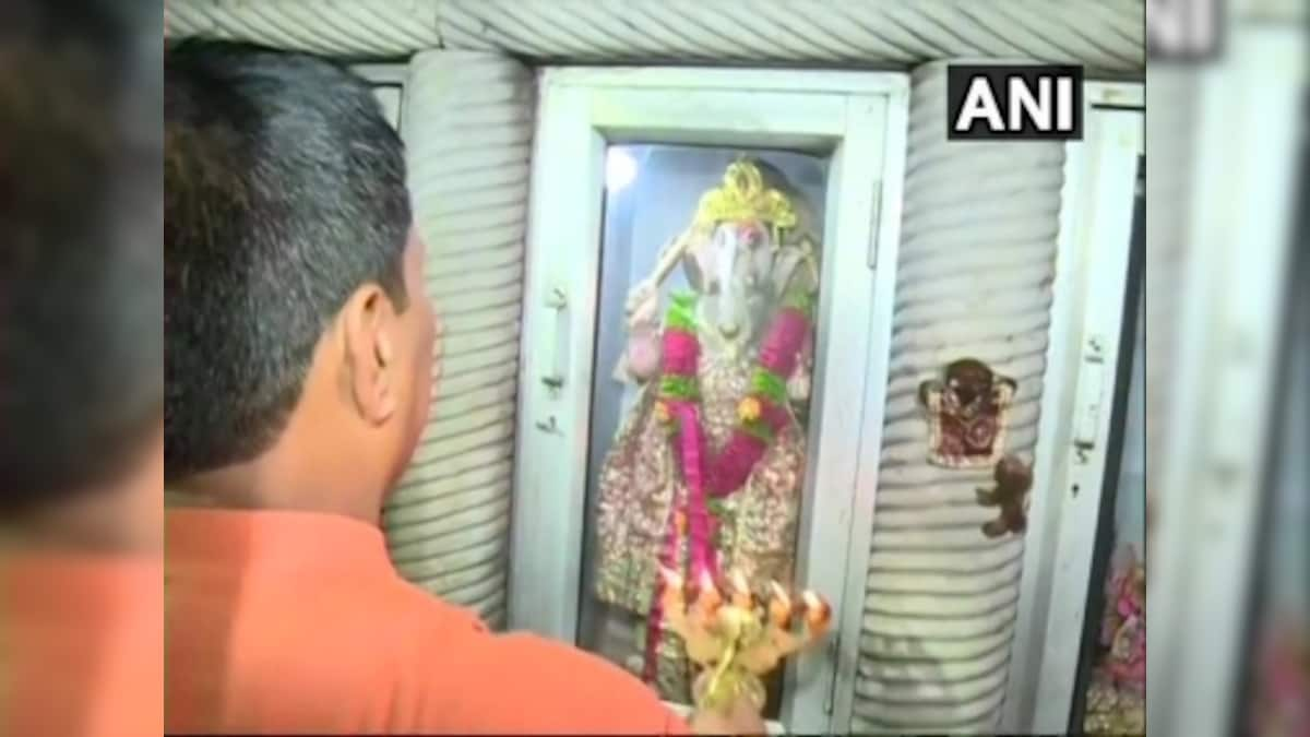 Locals offer prayers at Delhi's Durga temple vandalised during last week's clashes between two group