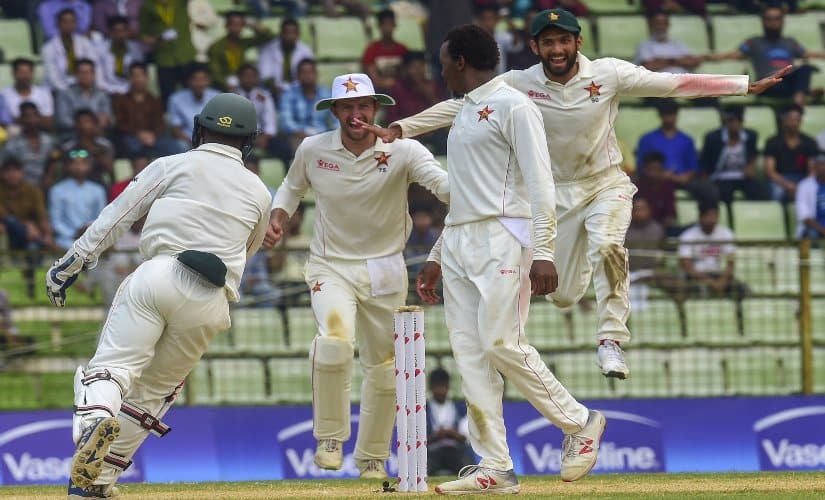 Zimbabwe cricketers celebrate after winning the match on the fourth day of the first Test cricket match against Bangladesh