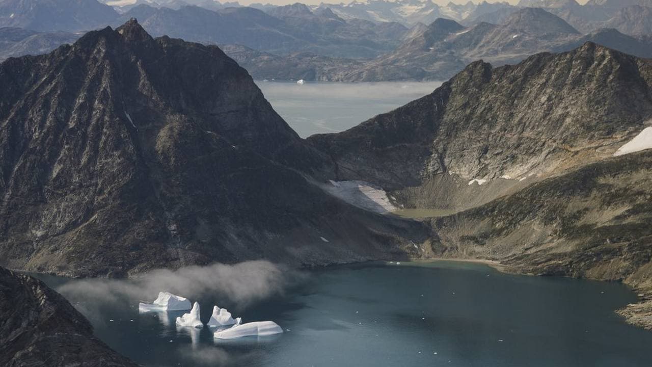 icebergs are photographed from the window of an airplane carrying NASA Scientists as they fly on a mission to track melting ice in eastern Greenland. Greenland has been melting faster in the last decade and this summer, it has seen two of the biggest melts on record since 2012. Image credit: AP Photo/Mstyslav Chernov)