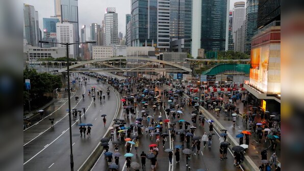 Hong Kong sees largest rally in weeks as protesters flood streets braving torrential rains despite warnings from Beijing