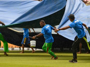 Ground staff pull rain covers during the 1st ODI match between West Indies and India at Guyana National Stadium in Providence, Guyana, on August 8, 2019. (Photo by Randy Brooks / AFP)