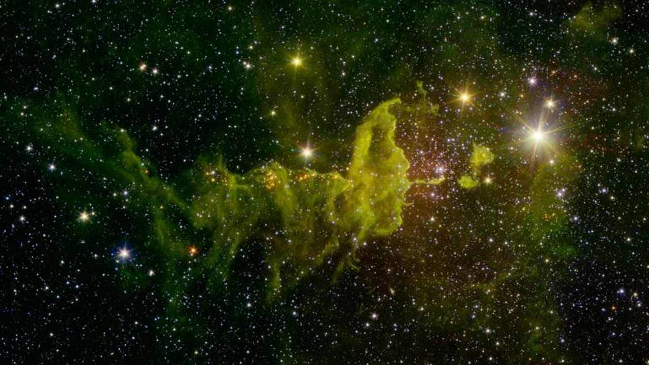 The Spider Nebula, located in the Auriga constellation, is 10,000 light-years away from the Earth. This image was formed by combining data from Spritzer and the Two Micron All-Sky Survey program. The green clouds in the image are dust clouds and indicative of star-formation in this region. Image credit: NASA/JPL The Spider Nebula, located in the Auriga constellation, is 10,000 light-years away from the Earth. This image was formed by combining data from Spritzer and the Two Micron All-Sky Survey program. The green clouds in the image are dust clouds and indicative of star-formation in this region. Image credit: NASA/JPL