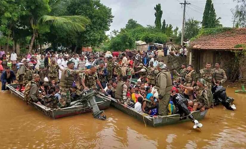 Army personnel carry out rescue operation in a flood affected area in Belgaum district of Karnataka. PTI