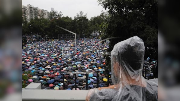 Hong Kong pro-democracy protesters march in show of 'peaceful' credentials as China takes hardline tone, issues warnings to 'terrorist-like' activities