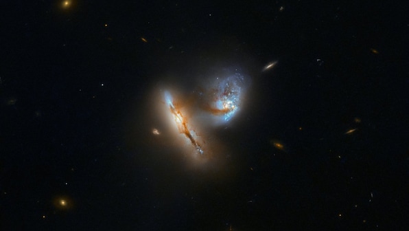 NASA's Hubble captures a pair of galaxies merging, distorting in spectacular detail