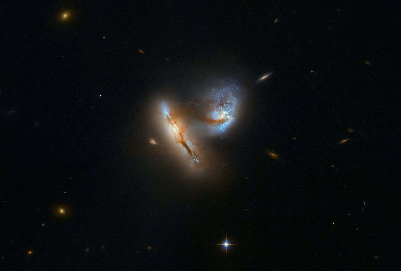 The pair of strange, luminescent creatures at play in this image are actually galaxies — realms of millions upon millions of stars. This galactic duo is known as UGC 2369. The galaxies are interacting, meaning that their mutual gravitational attraction is pulling them closer and closer together and distorting their shapes in the process. A tenuous bridge of gas, dust, and stars can be seen connecting the two galaxies,, during which they pulled material out into space across the diminishing divide between them.  Interaction with others is a common event in the history of most galaxies. For larger galaxies like the Milky Way, the majority of these interactions involve significantly smaller so-called dwarf galaxies. But every few aeons, a more momentous event can occur. For our home galaxy, the next big event will take place in about four billion years, when it will collide with its bigger neighbour, the Andromeda Galaxy. Over time, the two galaxies will likely merge into one — already nicknamed Milkomeda. Image: ESA/Hubble/NASA