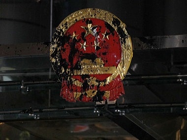 The National Emblem of the People’s Republic of China is covered in black paint thrown by protesters outside the Chinese Liaison Office in Hong Kong. AP