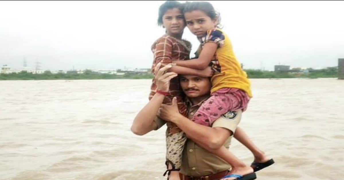 Gujarat constable carries two children on shoulders in waistdeep flood water to safety; video