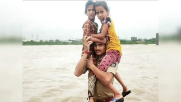 Gujarat constable carries two children on shoulders in waist-deep flood water to safety; video goes viral on social media, earns CM's praise
