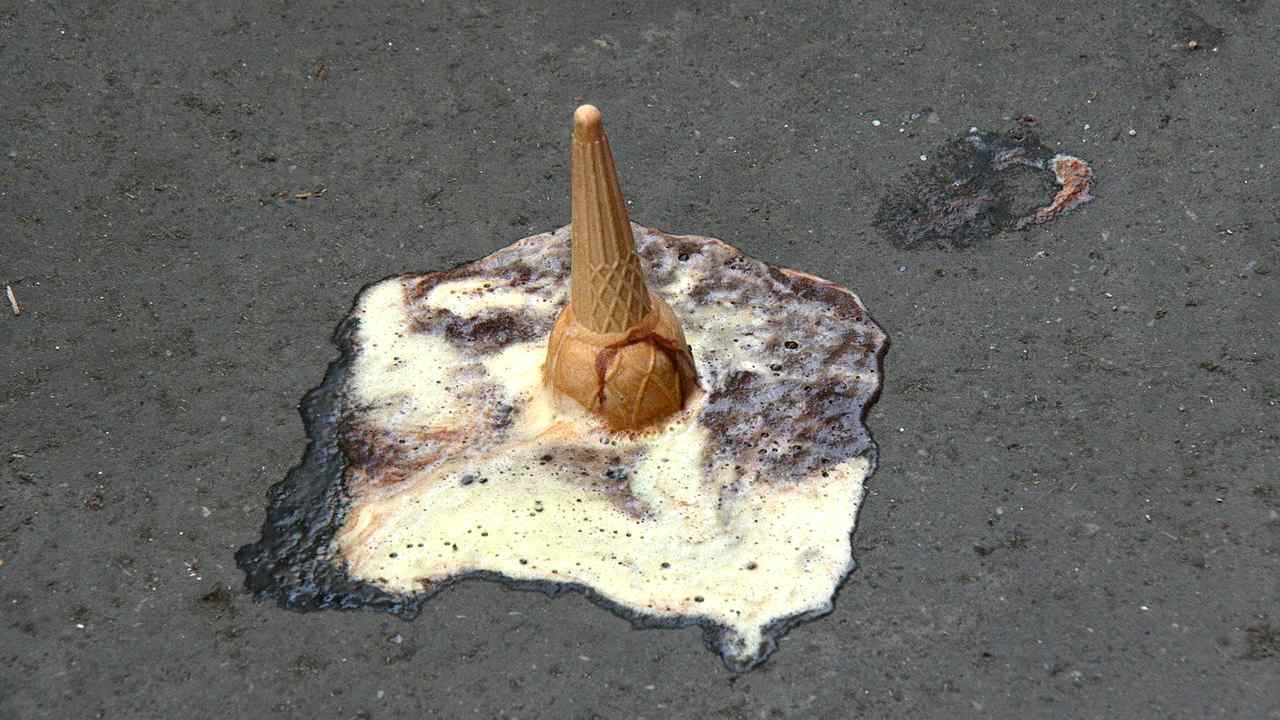 An ice cream cone spilt on the road.