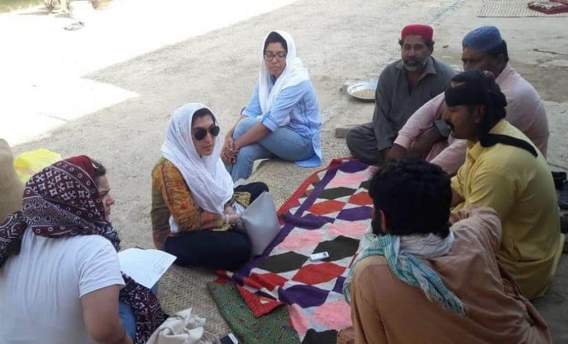 The Climate Stories Pakistan team listens to climate migrants from the Lake Manchar area. Image courtesy: Climate Stories Pakistan/National Geographic Society.