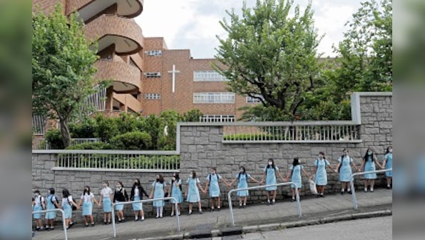 Hong Kong students form human chains to call on government to meet protesters' demands two days after Carrie Lam withdraws extradition bill