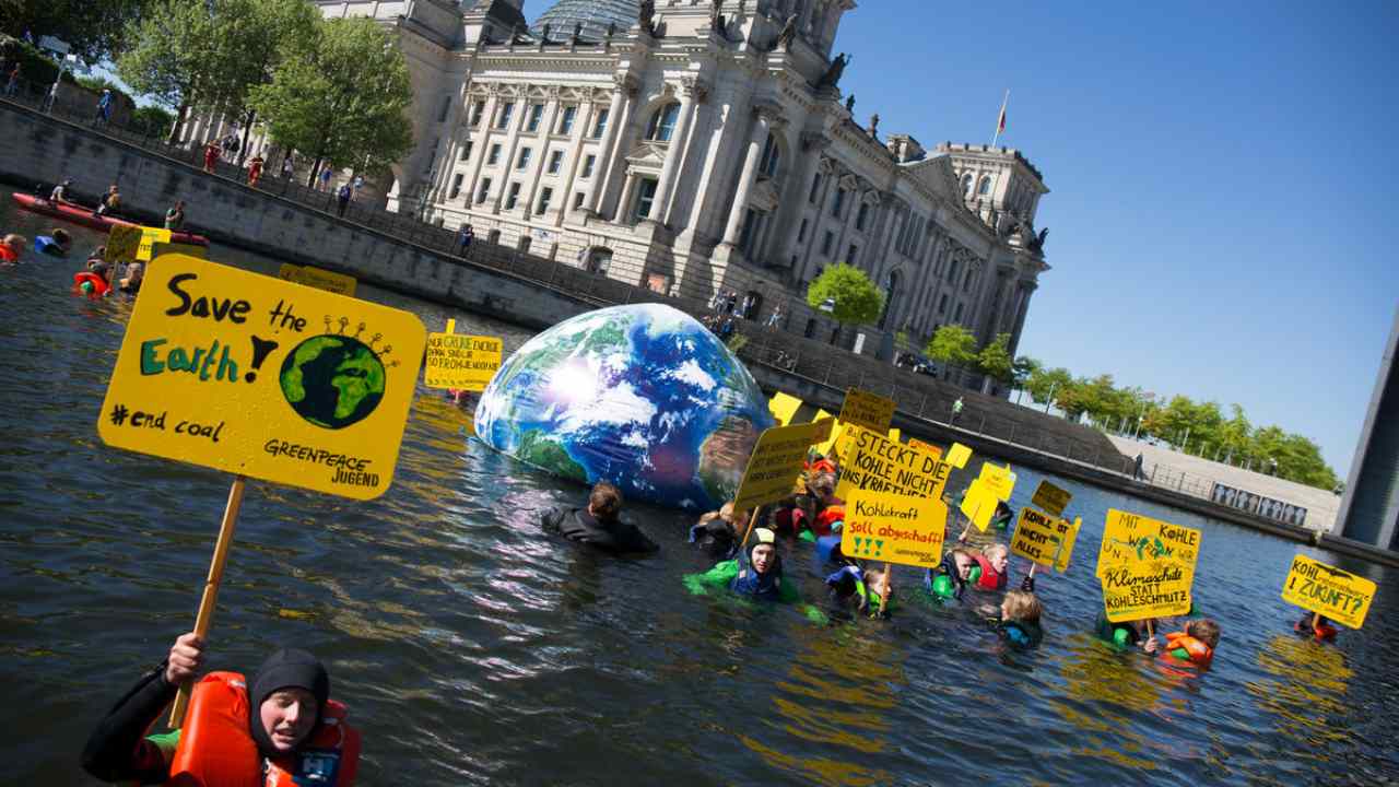 Protesters simulate an end-of-the-world flood theme to advocate urgent climate actions Greenpeace