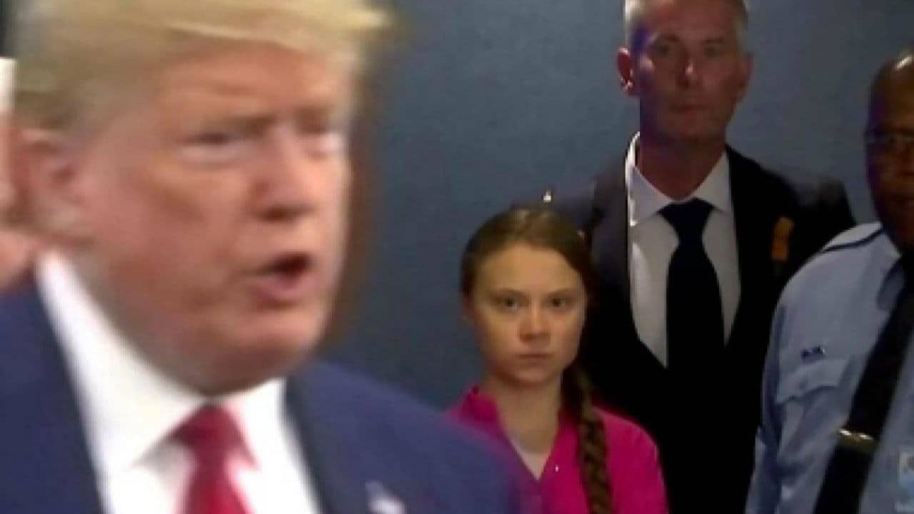 Greta Thunberg stars at Donald Trump when he passes her by. 