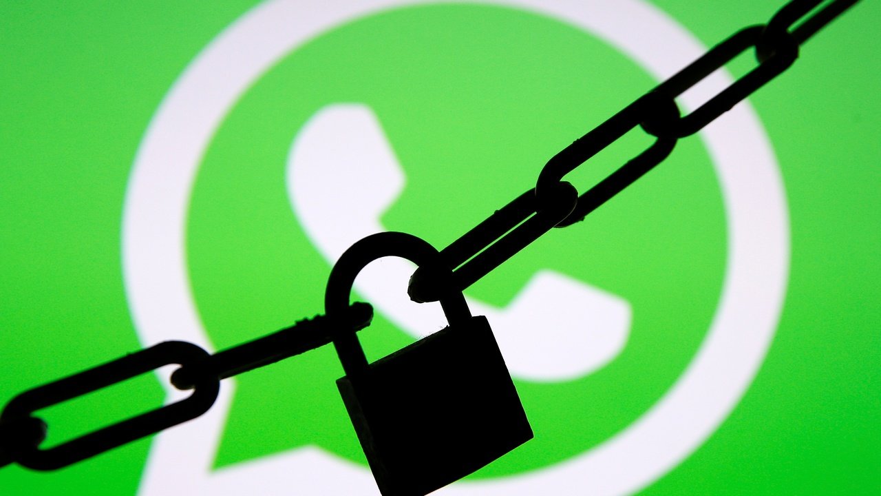 A photo illustration shows a chain and a padlock in front of a displayed Whatsapp logo January 13, 2017. REUTERS/Dado Ruvic/Illustration - RC13711464B0