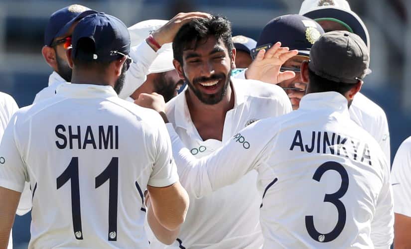 Jasprit Bumrah is congratulated by his teammates after getting his hat-trick. AP