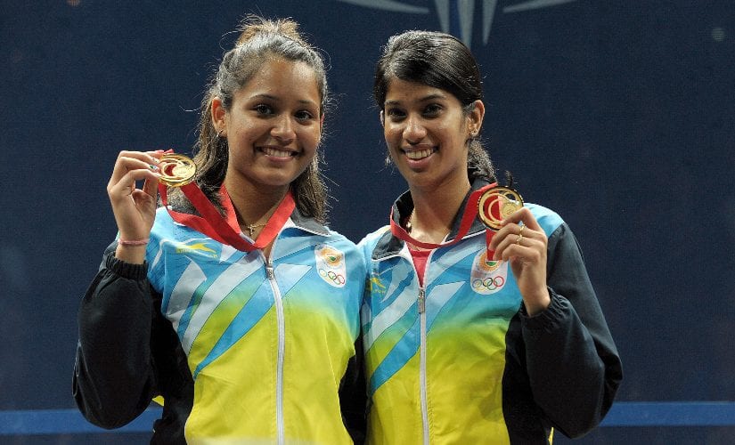 Gold medalists Dipika Pallikal (L) and Joshana Chinappa pose on the podium with their medals after winning the women’s doubles event during the 2014 Commonwealth Games in Glasgow, Scotland. AFP