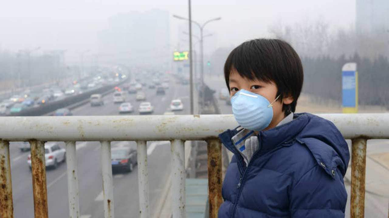 Severe air pollution can speed up neurodegeneration when the brain is at the peak of its development — during childhood. Pictured here, a child in Beijing. image credit: Shutterstock
