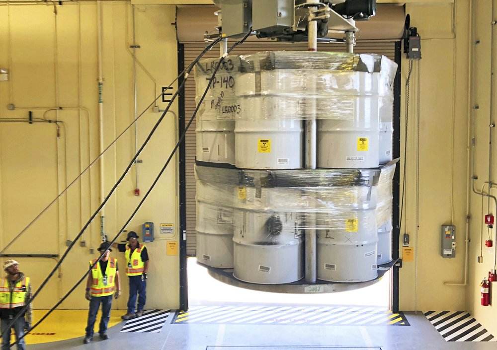 Barrels of radioactive waste are loaded for transport to the Waste Isolation Pilot Plant, marking the first transuranic waste loading operations in five years at the Radioactive Assay Nondestructive Testing (RANT) facility in Los Alamos. image credit: AP