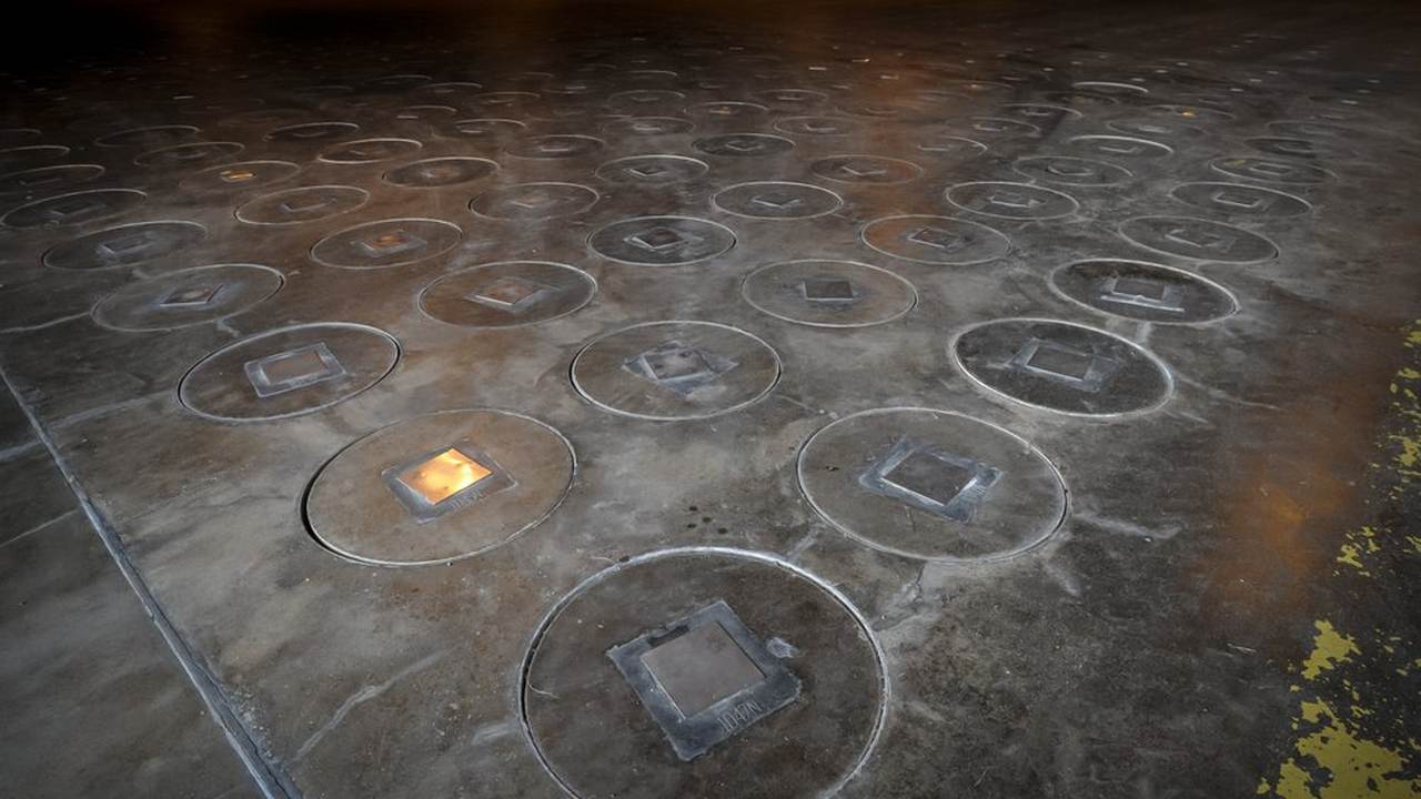 After radioactive waste is vitrified and sealed in large stainless steel canisters they are stored under a five-feet of concrete in a glass waste storage building at the Savannah River Site near Aiken. image credit: AP