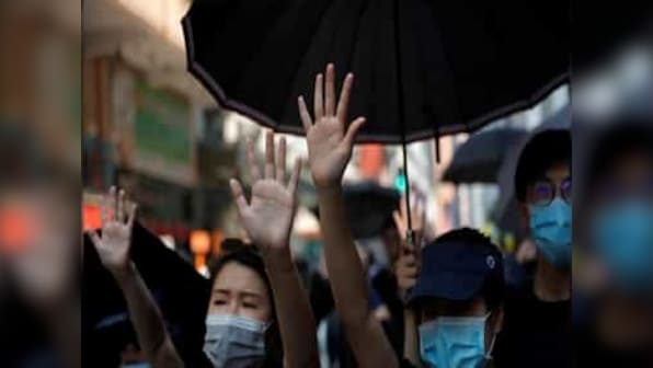As China marks 70th national day, police fire tear gas after Hong Kong protesters flood streets challenging Xi Jinping's celebrations
