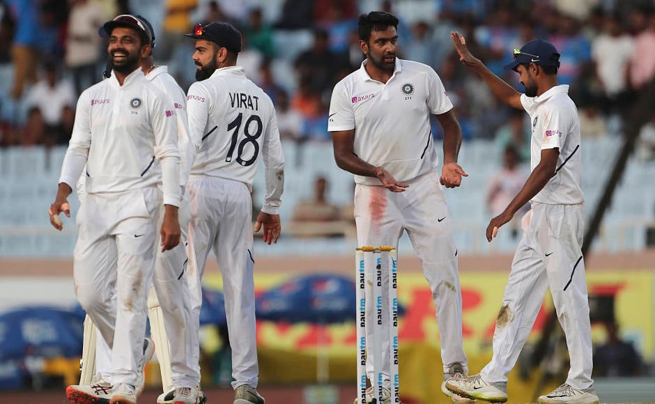 Ravichandran Ashwin and his India teammates celebrate the dismissal of Kagiso Rabada, who was the last to depart on another day dominated by the hosts. AP 
