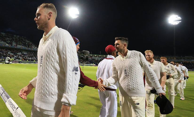England bowler Stuart Broad (L) and England's James Anderson (C) leave the pitch with teammates after their win on day 3 of the first Test cricket match between England and the West Indies at Edgbaston in Birmingham, central England on August 19, 2017. - England hammered the West Indies by an innings and 209 runs as the inaugural day/night Test in Britain ended inside three days at Edgbaston on Saturday. (Photo by Lindsey PARNABY / AFP) / RESTRICTED TO EDITORIAL USE. NO ASSOCIATION WITH DIRECT COMPETITOR OF SPONSOR, PARTNER, OR SUPPLIER OF THE ECB