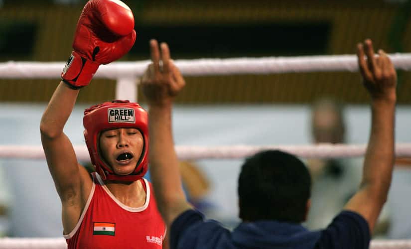 Indian boxer Sarita Devi (L) celebrates along with her coach after she won gold in the 52 Kg weight category defeating her Ukrainian opponent Viktoria Rudenko during their bout in finals of 52 Kg weight category at the Fourth World Women Boxing Championship in New Delhi, 23 November 2006. India won the world championship and Russia were runners up at the Championships which took place in the Indian capital from 18-23 November. AFP PHOTO/ Manpreet ROMANA (Photo by MANPREET ROMANA / AFP)
