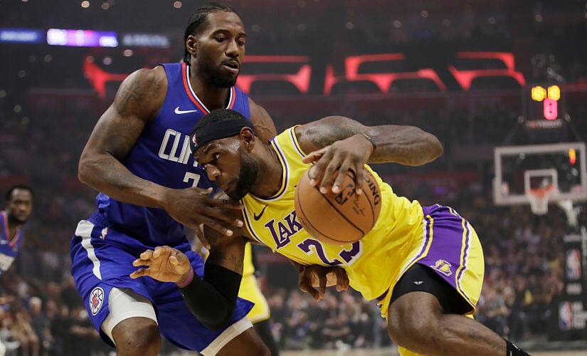 Los Angeles Lakers' LeBron James, right, is defended by Los Angeles Clippers' Kawhi Leonard. AP Photo