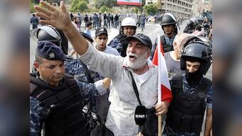 Protestors in Lebanon take to streets for 10th day, demand remove of 'systematically corrupt' political class; Hezbollah supporters defy call to stem unrest