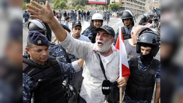 Protestors in Lebanon take to streets for 10th day, demand remove of 'systematically corrupt' political class; Hezbollah supporters defy call to stem unrest