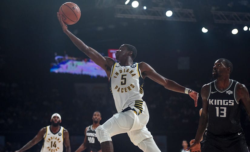 Indiana Pacers player Edmond Sumner (left) leaps for a lay-up at the NSCI Dome on Saturday. AFP