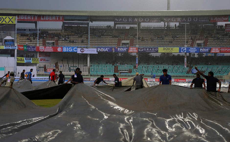 Covers are brought onto the ground after heavy rain forced the players off the field. The rain made it’s appearance by tea time and the post-tea session was completely washed out. AP 