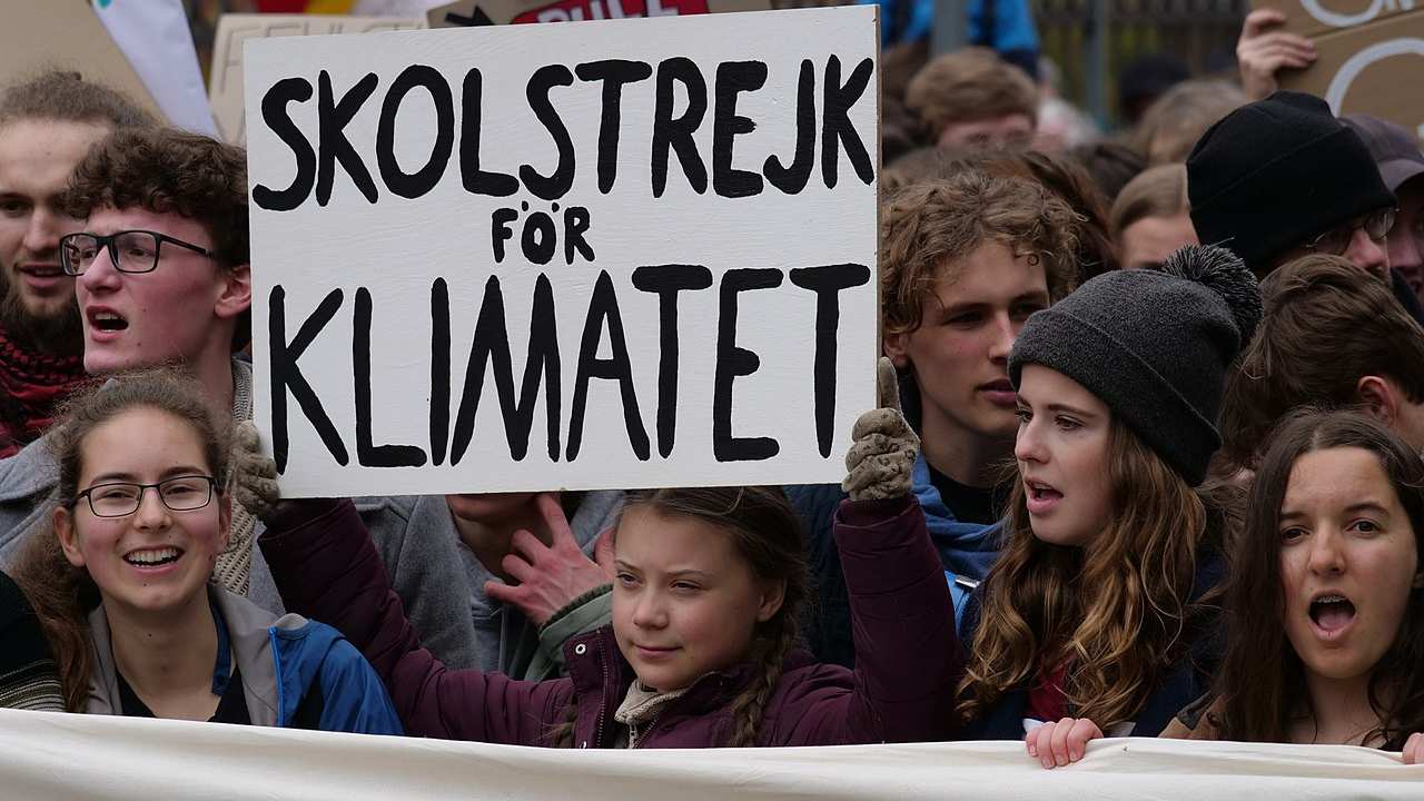 Greta Thunberg stands with School strike for the climate sign during a strike. Image credit: Wikipedia/Leonhard Lenz