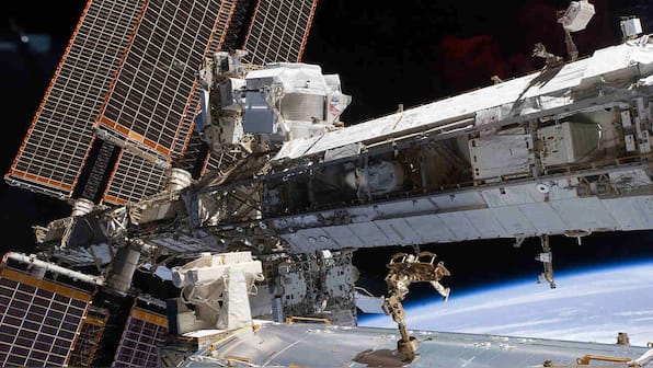 Astronauts completes first in a series of spacewalks to fix cosmic ray detector on the ISS