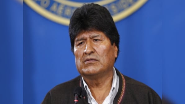 Bolivia's interim president threatens to prosecute exiled leader Evo Morales if he returns; ex-premier had offered to come back to country quell political protests
