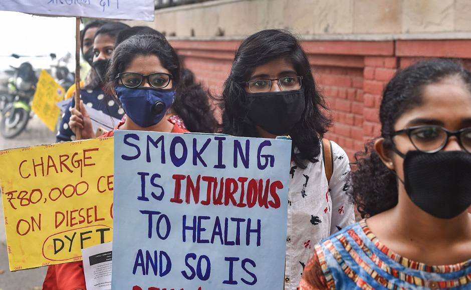 Members of Democratic Youth Federation of India (Delhi) and Jan Swasthya Abhiyan(Delhi) wearing masks display placards during a protest march demanding implementation of measures to reduce air pollution the capital. PTI