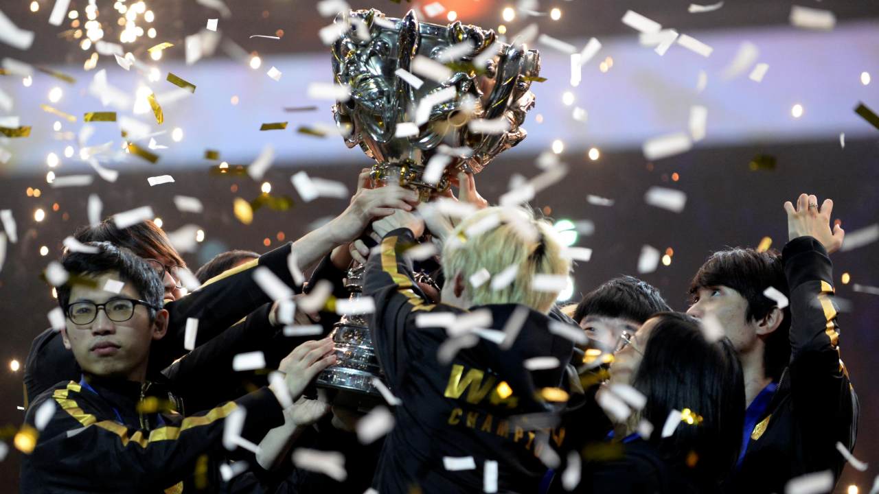 Team FunPlus Phoenix members raise the trophy after winning the League of Legends (LOL) World Championship Finals in Paris, France. Image: Reuters