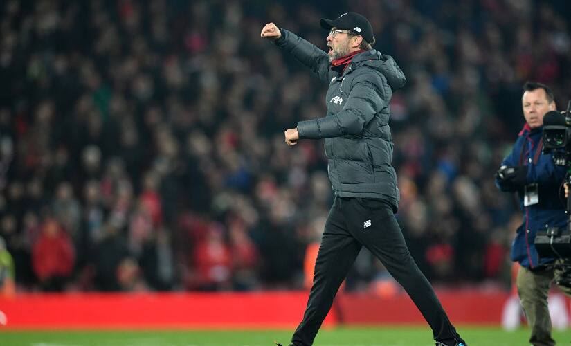 Liverpool manager Jurgen Klopp celebrates on the pitch after their win over Manchester City at Anfield. AFP
