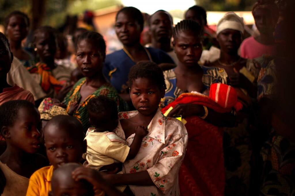 Residents listen to information about a measles outbreak 15 December 2007 in Ouandango, northern Central African Republic. Image: Getty
