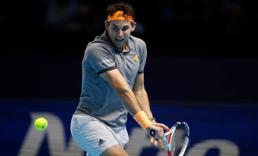 Dominic Thiem plays a backhand against Novak Djokovic during their match at the ATP Finals 2019. AP